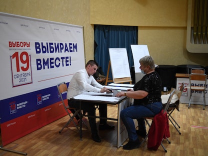 أعضاء من لجنة الانتخابات بالعاصمة الروسية موسكو يعملون على تجهيز أوراق الاقتراع - 16 سبتمبر 2021 - AFP