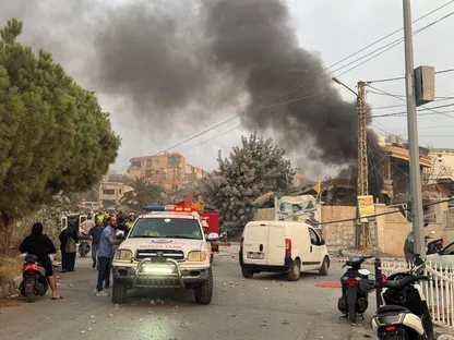 أشخاص يتجمعون مع تصاعد الدخان بعد غارات إسرائيلية في طير دبا بجنوب لبنان. 6 نوفمبر 2025 - Reuters