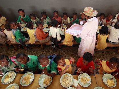 أطفال في مدغشقر يتناولون الطعام في إطار مبادرة لبرنامج الغذاء العالمي في ضاحية لأنتاناناريفو - 28 أكتوبر 2013 - REUTERS
