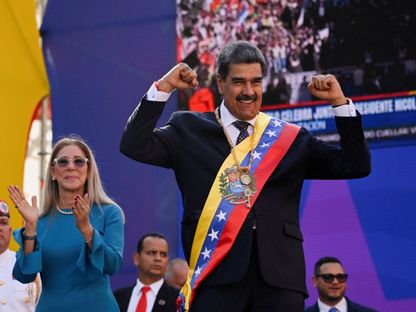 الرئيس الفنزويلي نيكولاس مادورو يحيي أنصاره بجوار زوجته سيليا فلوريس بعد أدائه اليمين الدستورية لولاية ثالثة مدتها ست سنوات، في كاراكاس، فنزويلا. 10 يناير 2025 - reuters