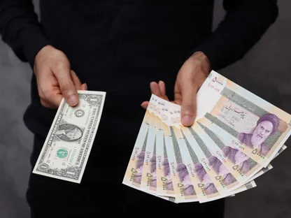تاجر عملات يحمل ورقة نقدية من فئة دولار أميركي واحد، والمبلغ المقابل له عند تحويله إلى الريال الإيراني، داخل محل صرافة في طهران، إيران، 25 ديسمبر 2022 - REUTERS