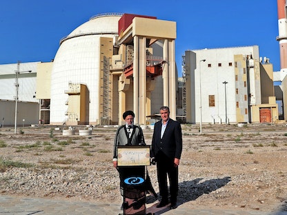 الرئيس الإيراني إبراهيم رئيسي (إلى اليمين) يرافقه رئيس هيئة الطاقة الذرية الإيرانية محمد إسلامي أثناء زيارته لمحطة بوشهر للطاقة النووية - 8 أكتوبر 2021 - AFP