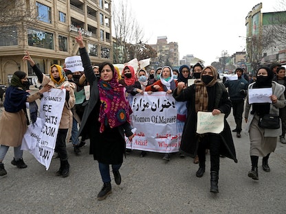 أفغانيات يهتفن بشعارات ويحملن لافتات خلال مسيرة احتجاجية لحقوق المرأة في العاصمة كابول - 16 يناير 2022 - AFP