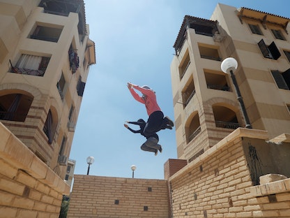 نساء مصريات من "باركور مصر" (PKE) يمارسن مهاراتهن في اللعبة حول المباني، القاهرة - 20 يوليو 2018. - REUTERS