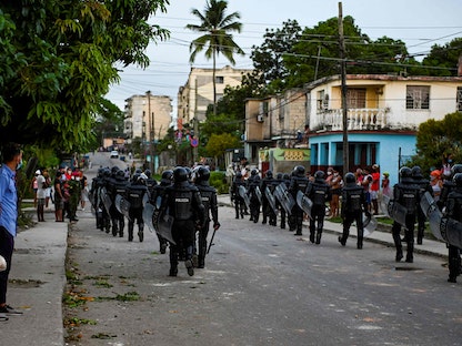 شرطة مكافحة الشغب الكوبية تسير في الشوارع بعد مظاهرة ضد حكومة الرئيس ميغيل دياز كانيل، في بلدية أرويو نارانجو في العاصمة هافانا. 12 يوليو 2021 - AFP