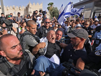 الشرطة الإسرائيلية تعتقل رجلاً فلسطينياً حاول اعتراض "مسيرة الأعلام" في القدس المحتلة – 29 مايو 2022 - AFP