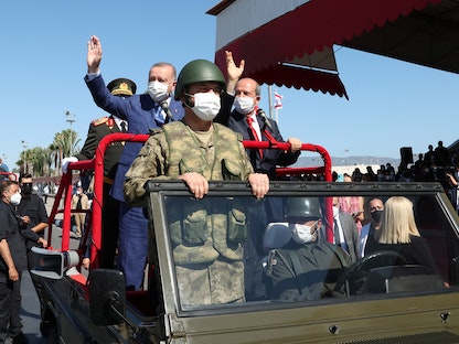 الرئيس التركي رجب طيب أردوغان وزعيم القبارصة الأتراك أرسين تتار خلال حضورهما عرضاً عسكرياَ في جمهورية شمال قبرص التي لا يعترف بها غير أنقرة، 20 يوليو 2021 - REUTERS