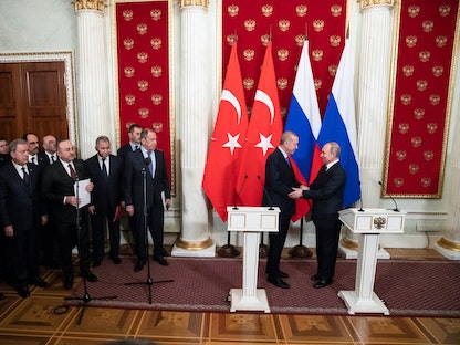 الرئيس الروسي فلاديمير بوتين يصافح الرئيس التركي رجب طيب أردوغان خلال اجتماع في موسكو- 5 مارس 2020 - REUTERS