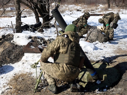 جنود أوكرانيون يستعدون لإطلاق قذيفة هاون باتجاه الموقع الروسي على خط أمامي ليس بعيداً عن باخموت في منطقة دونيتسك- 20 فبراير 2023 - AFP