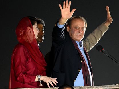 رئيس الوزراء الباكستاني السابق نواز شريف، وبجواره ابنته مريم، يلوح لأنصاره خلال حفل للترحيب بعودته في لاهور- 21 أكتوبر 2023 - AFP