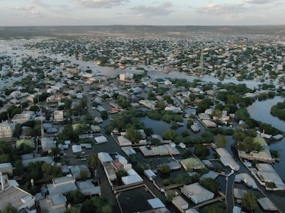 This aerial view shows floodwater in Beledweyne, central Somalia, on May 12, 2023. The Shabelle River has burst its banks in Beledweyne, in central Somalia, forcing thousands of people to abandon their homes, according to the United Nations Office for the Coordination of Humanitarian Affairs (OCHA), and submerging markets and hospitals. (Photo by Hasan Ali Elmi / AFP) - AFP