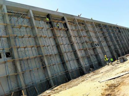 عمال مصريون خلال تشطيب أحد المباني من الخارج قبل تطبيق قرار وقف تراخيص البناء - خاص الشرق