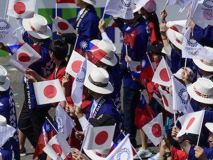 مجموعة من اليابانيين يحملون أعلام اليابان وتايبيه و"أولمبياد طوكيو" خلال احتفالات أمام قصر الرئاسي في تايبيه. 10 أكتوبر 2019 - Getty