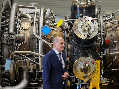 المستشار الألماني أولاف شولتز أمام إحدى وحدات إنتاج الطاقة الكهربائية التابعة لشركة "سيمنز" في مدينة مولهايم - 3 أغسطس 2022  - REUTERS