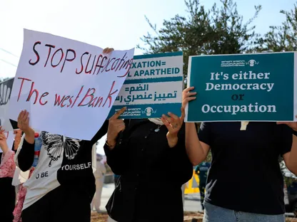 متظاهرون يرفعون لافتات خلال احتجاج لنشطاء فلسطينيين وإسرائيليين بالقرب من بيت جالا في الضفة الغربية ضد مساعي إسرائيل لضم الضفة المحتلة. 5 سبتمبر 2025 - REUTERS