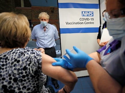 رئيس الوزراء البريطاني بوريس جونسون يشاهد عملية تطعيم بلقاح "فايزر-بيونتك" في مستشفى غاي بلندن  - REUTERS