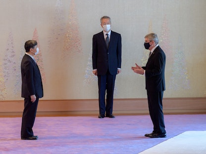 رئيس اللجنة الأولمبية الدولية توماس باخ في حديث مع إمبراطور اليابان - via REUTERS