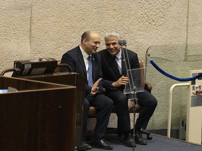 رئيس الوزراء الإسرائيلي نفتالي بينيت (يسار) ووزير الخارجية يائير لبيد خلال جلسة في الكنيست - 27 يونيو 2022 - Bloomberg