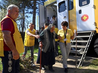 متطوعو تحالف من أجل اتحاد الرومانيين يساعدون مسنة قروية لتلقي خدمات طبية في شاحنة مزودة بمعدات طبية في لوديستي برومانيا. 10 أبريل 2024 - reuters