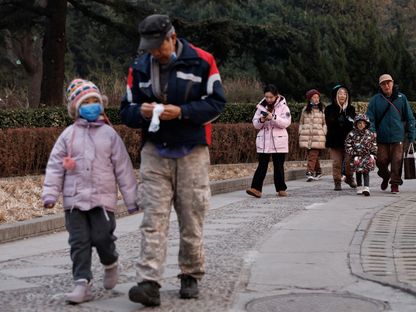 أشخاص يسيرون في أحد حدائق العاصمة الصينية بكين. 12 يناير 2024 - Reuters