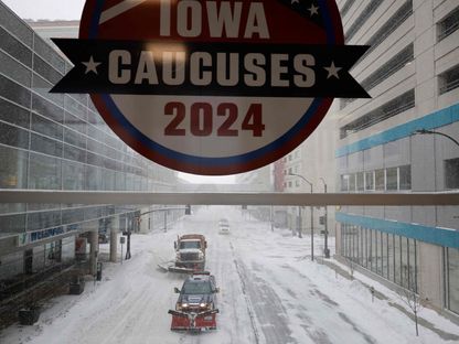 DES MOINES, IOWA - JANUARY 12: Plow trucks clear Grand Avenue as high winds and snow from winter storm Gerri four days before the Iowa caucuses on January 12, 2024 in Des Moines, Iowa. Republican presidential candidates postponed or cancelled many campaign events in Iowa days before the all-important caucuses, the first primary competition of the 2024 election year.   Chip Somodevilla/Getty Images/AFP (Photo by CHIP SOMODEVILLA / GETTY IMAGES NORTH AMERICA / Getty Images via AFP) - Getty Images via AFP