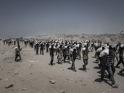 فلسطينيون يحملون مساعدات إغاثية، في بيت لاهيا، شمال قطاع غزة، الأحد 27 يوليو 2025 - Bloomberg