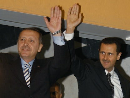 الرئيسان السوري بشار الأسد والتركي رجب طيب أردوغان يلوحان للجماهير خلال افتتاح ستاد حلب في سوريا. 3 أبريل 2007 - REUTERS