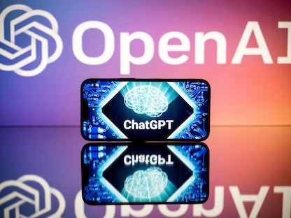 شعار ChatGPT أمام شعار شركة Open AI المطورة للتطبيق. 23 يناير 2023 - AFP