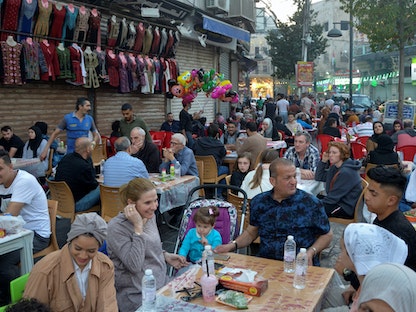 مجموعة من الناس تنتظر وجبات الإفطار خلال شهر رمضان في العاصمة الأردنية عمّان. 9 أبريل 2022 - REUTERS