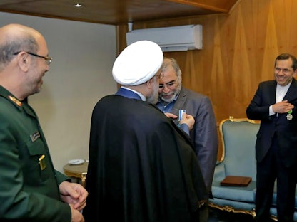 الرئيس الإيراني حسن روحاني يقلد العالم النووي محسن فخري زاده وسام تقدير في العاصمة الإيرانية طهران - AFP