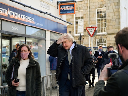 رئيس الوزراء البريطاني بوريس جونسون أثناء سيره لزيارة متجر في ترورو - REUTERS