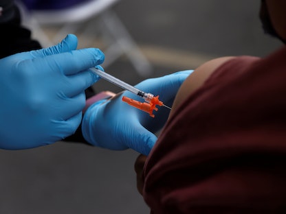 شخص يتلقى الجرعة الثانية من لقاح كورونا في أحد مراكز التطعيم بولاية كاليفورنيا الأميركية- 29 يناير 2022 - REUTERS