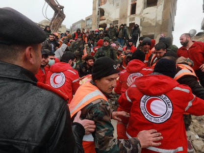 فرق إنقاذ سورية تبحث عن ضحايا وناجين تحت أنقاض مبنى منهار في مدينة حلب إثر الزلزال. 6 فبراير 2023 - AFP