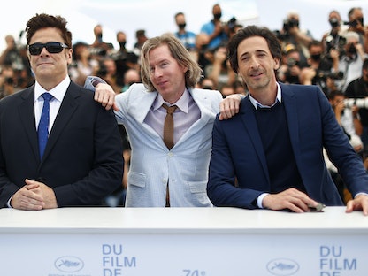مخرج فيلم "ذا فرنش ديسباتش" ويس أندرسون بجانب الممثلَين بينيشيو ديل تورو وأدريان برودي في مهرجان كان السينمائي بفرنسا - REUTERS
