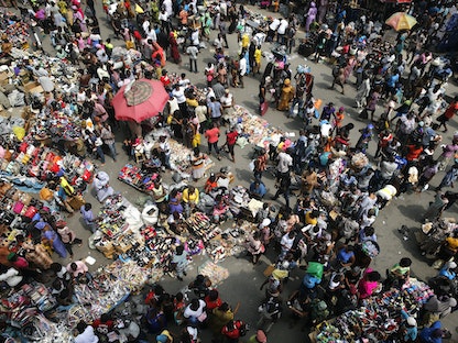 People crowd a market square at the central business district, a day before Christmas, in Lagos - REUTERS
