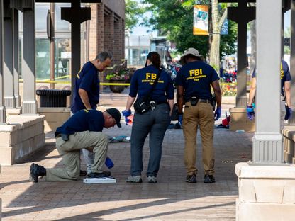 عملاء مكتب التحقيقات الفيدرالي في موقع إطلاق النار بهايلاند بارك، في إلينوي بشيكاغو. 5 يوليو 2022 - AFP
