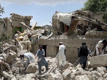 رجال أفغان يبحثون عن ناجين وسط حطام منزل دمره زلزال في جايان بأفغانستان في 23 يونيو 2022 - REUTERS
