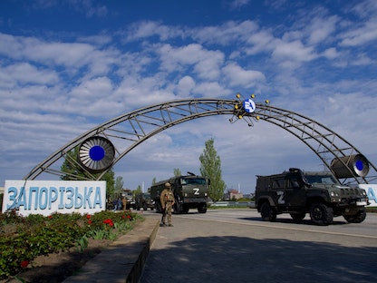 عربات عسكرية روسية تمر عبر المدخل الرئيسي لمحطة زابوروجيا للطاقة النووية في جنوب شرقي أوكرانيا - 1 مايو 2022 - AFP