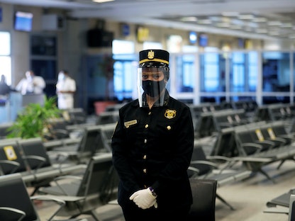 شرطية ترتدي قناعاً للوجه في مطار شرم الشيخ الدولي، 20 يونيو 2020 - REUTERS