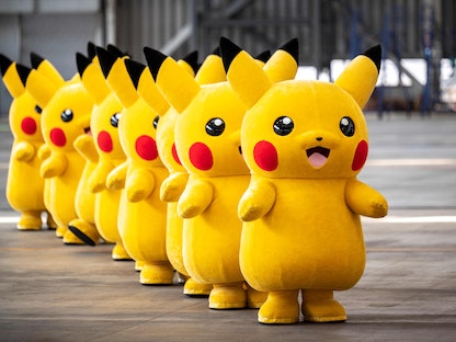 Pikachu mascots are seen during the unveiling of new Pokemon-themed livery on a Skymark Airlines Boeing 737-800 aircraft at Tokyo's Haneda international airport on June 21, 2021. (Photo by Charly TRIBALLEAU / AFP) - AFP