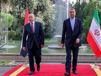 وزير الخارجية الإيراني حسين أمير عبد اللهيان يستقبل نظيره العراقي فؤاد حسين في طهران - 13 أبريل 2022 - AFP