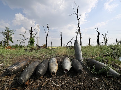 قذائف مدفعية على الأرض قرب آليات عسكرية روسية مدمّرة في جوار مدينة ميكولايف جنوب أوكرانيا - 12 يونيو 2022 - AFP