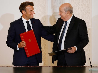 الرئيس الجزائري عبد المجيد تبون مع نظيره الفرنسي إيمانويل ماكرون خلال توقيع اتفاق الشراكة المتجددة في الجزائر - 27 أغسطس 2022  - AFP