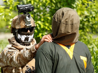 جندي تابع للقوات الأفغانية يرافق موقوفاً من حركة طالبان - REUTERS