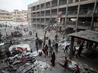 فلسطينيون يتفقدون الأضرار التي لحقت بمدرسة في مدينة غزة. 30 يونيو 2025 - REUTERS