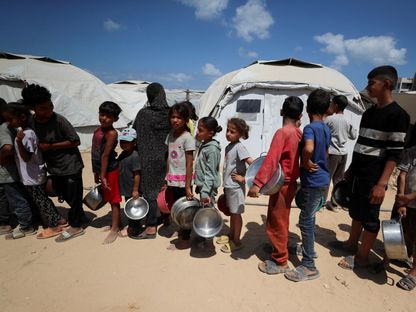 فلسطينيون في مدينة غزة ينتظرون الحصول على طعام من مطبخ خيري بعد نزوحهم بسبب الهجوم العسكري الإسرائيلي. 28 مايو 2025 - REUTERS