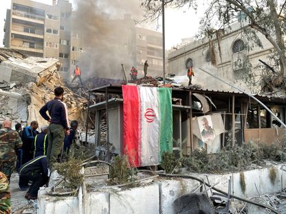 علم إيران فوق قنصليتها بالعاصمة السورية دمشق في أعقاب قصف إسرائيلي. 1 أبريل 2024 - REUTERS