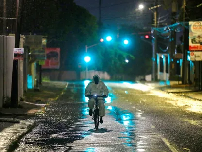 رجل يرتدي بدلة واقية يركب دراجته في أحد الشوارع مع اقتراب إعصار ميليسا في كينجستون. جامايكا في 27 أكتوبر 2025 - reuters