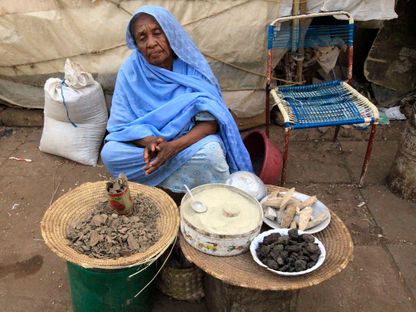 امرأة سودانية تبيع بعض المنتجات الشعبية في أحد أسواق الخرطوم - REUTERS