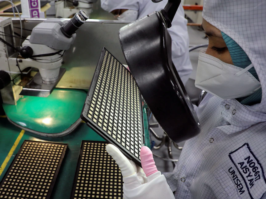 عامل يتفقد الرقائق في مصنع تعبئة أشباه الموصلات في إيبوه، ماليزيا. 15 أكتوبر 2021 - REUTERS